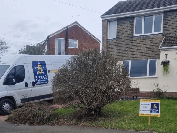 New Extreme windows into a half tile, half rendered house with 5 Star van on driveway inner.