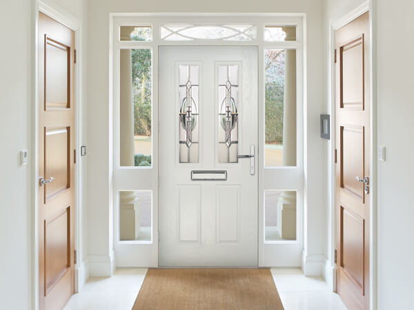 An internal view of a white Forte Composite front Door with side panels and fanlights.