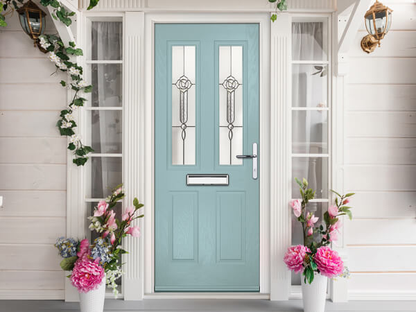 A Traditional blue Forte Composite front Door with decorative columns and side glass panels.