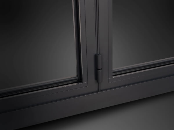 A close up Origin Soho Collection OB-36+ hinge and powder coated aluminium profile in anthracite grey with gasket and glass detail.
