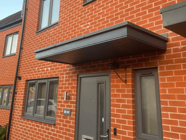 New Entrance Canopies - Modern Flat Anthracite Canopy against red brick wall