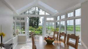 The Inside Of An Extension With A Dining Table And Opened French Doors
