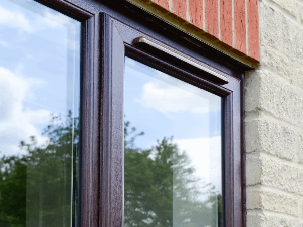 A rosewood window with trickle vent above the opening sash