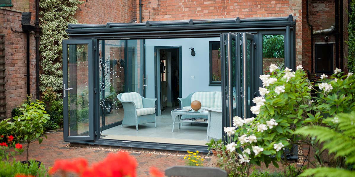 Grey Lean-To Conservatory With Bi-Folding Doors