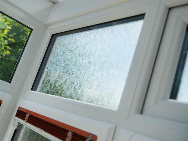 Privacy Glazing In White Window With Daisy Pattern Looking Out