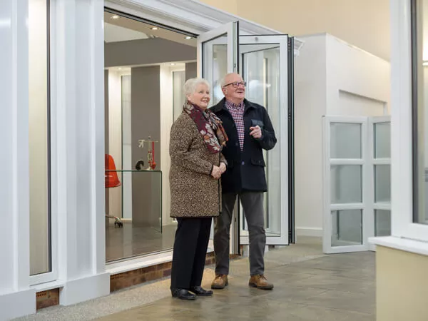 A couple visiting our 5 Star showroom, standing by bi folding doors.