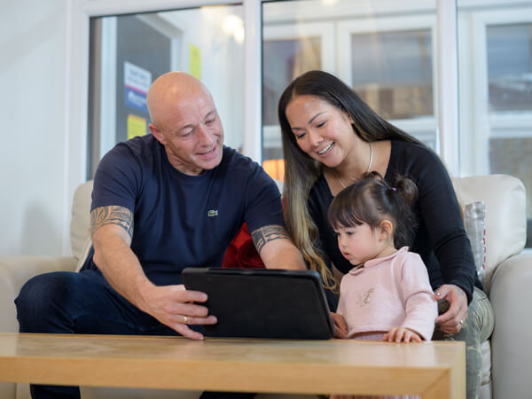 Couple With Small Child On Computer In Our 5 Star Worcester Showroom